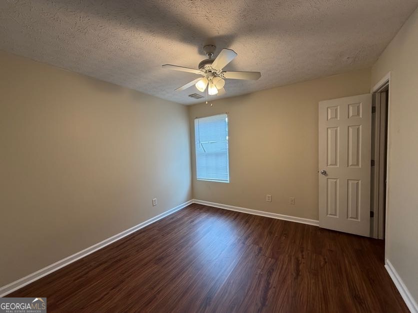 5196 Tew Lane Southwest Covington, GA 30014 - Photo 11 of 41 a view of an empty room with wooden floor