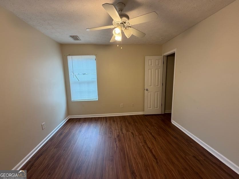 5196 Tew Lane Southwest Covington, GA 30014 - Photo 12 of 41 wooden floor in an empty room with a window