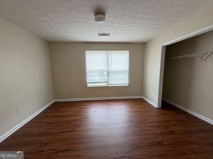 5196 Tew Lane Southwest Covington, GA 30014 - Photo 21 of 41 an empty room with wooden floor and windows
