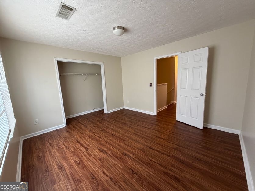 5196 Tew Lane Southwest Covington, GA 30014 - Photo 22 of 41 an empty room with wooden floor and closet