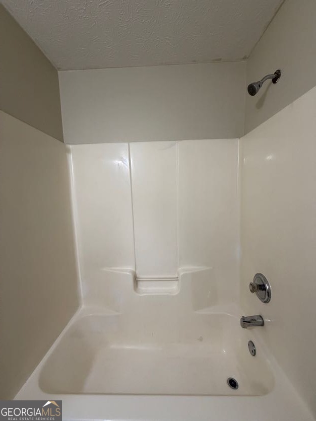5196 Tew Lane Southwest Covington, GA 30014 - Photo 28 of 41 a bathroom with a bathtub
