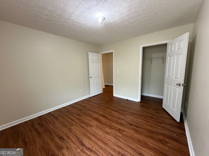 5196 Tew Lane Southwest Covington, GA 30014 - Photo 30 of 41 a view of an empty room with wooden floor