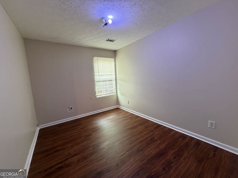 5196 Tew Lane Southwest Covington, GA 30014 - Photo 31 of 41 an empty room with wooden floor and windows