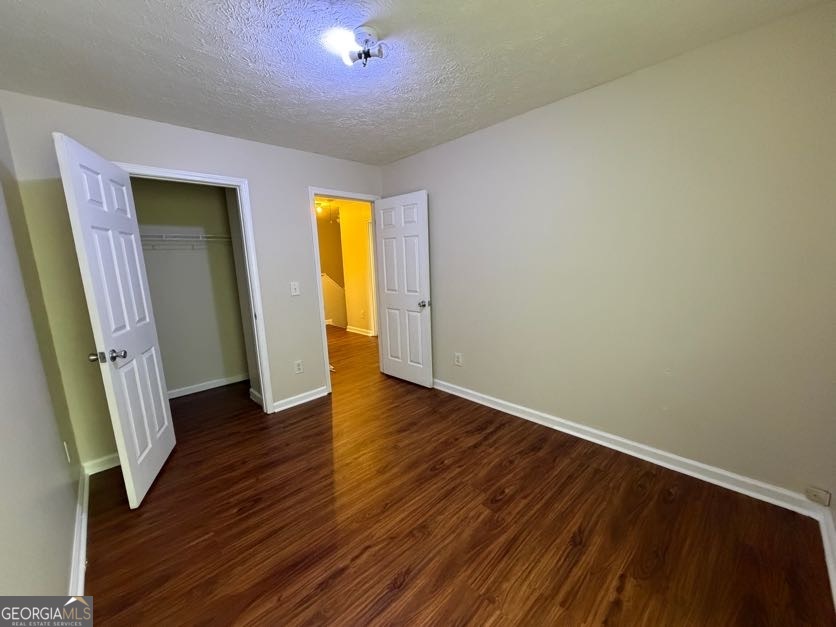 5196 Tew Lane Southwest Covington, GA 30014 - Photo 32 of 41 an empty room with wooden floor and closet