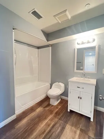 a bathroom with a sink mirror vanity and a toilet