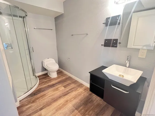 a bathroom with a sink toilet and shower