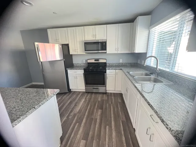 a kitchen with a sink stove and microwave