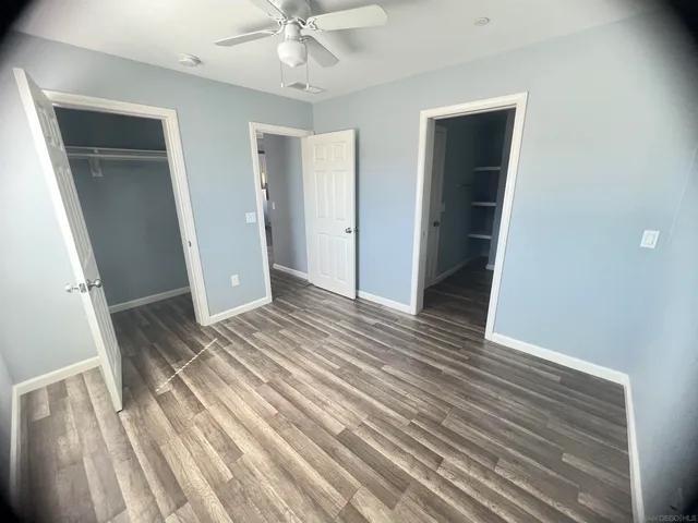 a view of a room with wooden floor and staircase
