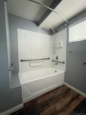 a bathroom with a bathtub and a shower