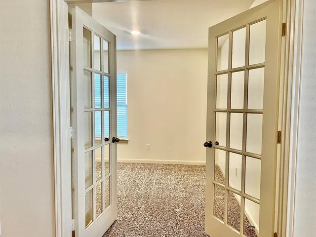 an empty room with windows and closet