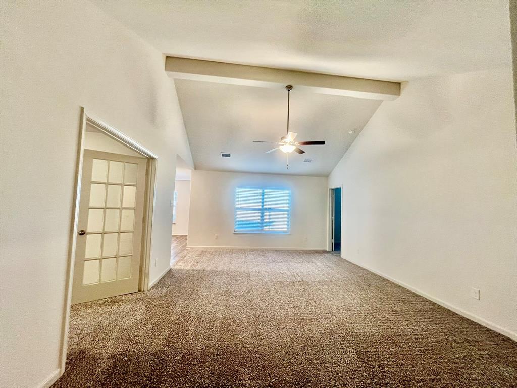 1814 Fergus Drive Ponder, TX 76259 - Photo 19 of 39 an empty room with windows and chandelier fan
