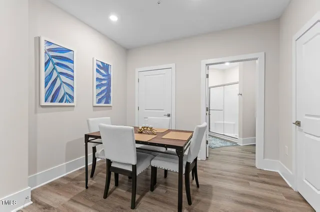 a view of a room with furniture and wooden floor