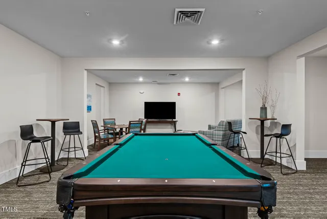 a room with chairs and pool table