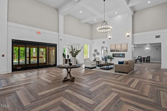 a living room with furniture kitchen view and a large window