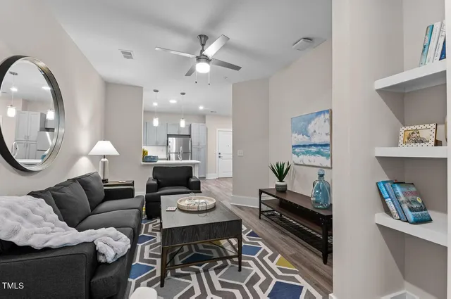 a living room with furniture and a mirror