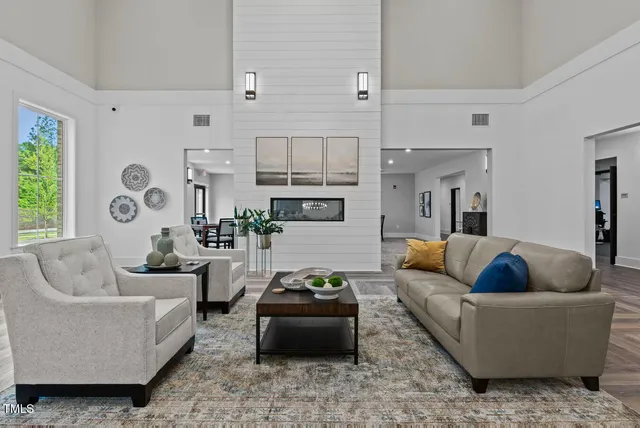 a living room with furniture fireplace and window