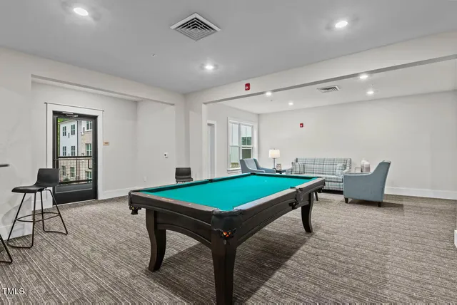 a room with furniture and pool table