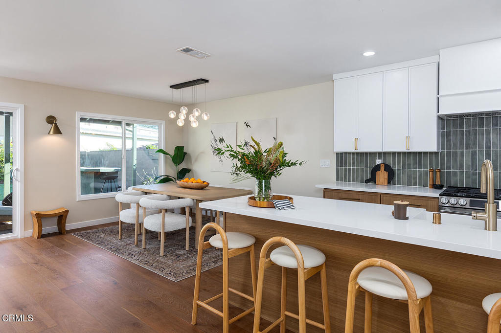 2650 Catherine Road Altadena, CA 91001 - Photo 13 of 37 a kitchen with stainless steel appliances granite countertop a table chairs sink and cabinets