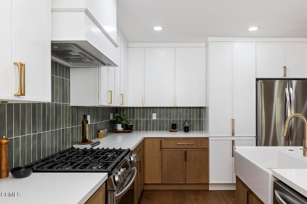 2650 Catherine Road Altadena, CA 91001 - Photo 15 of 37 a kitchen with white cabinets and a stove