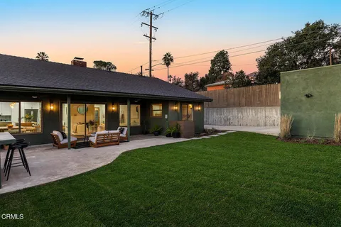 a view of a house with backyard and porch