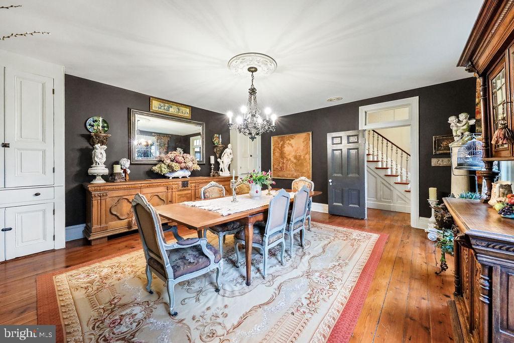9 Eayrestown Road Medford, NJ 08055 - Photo 27 of 78 a dining room with wooden floor a chandelier a wooden table and chairs