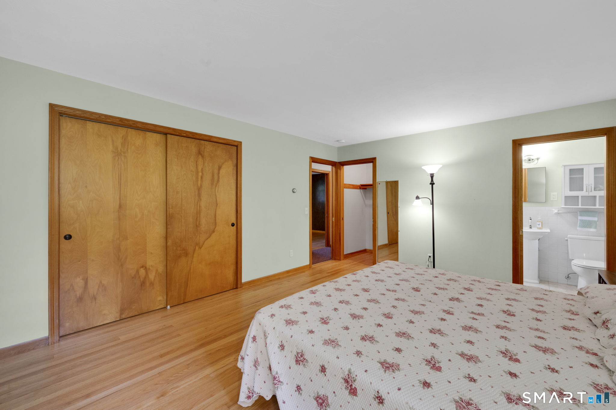 158 Notch Road Granby, CT 06035 - Photo 22 of 40 a bedroom with a large bed and wooden floor