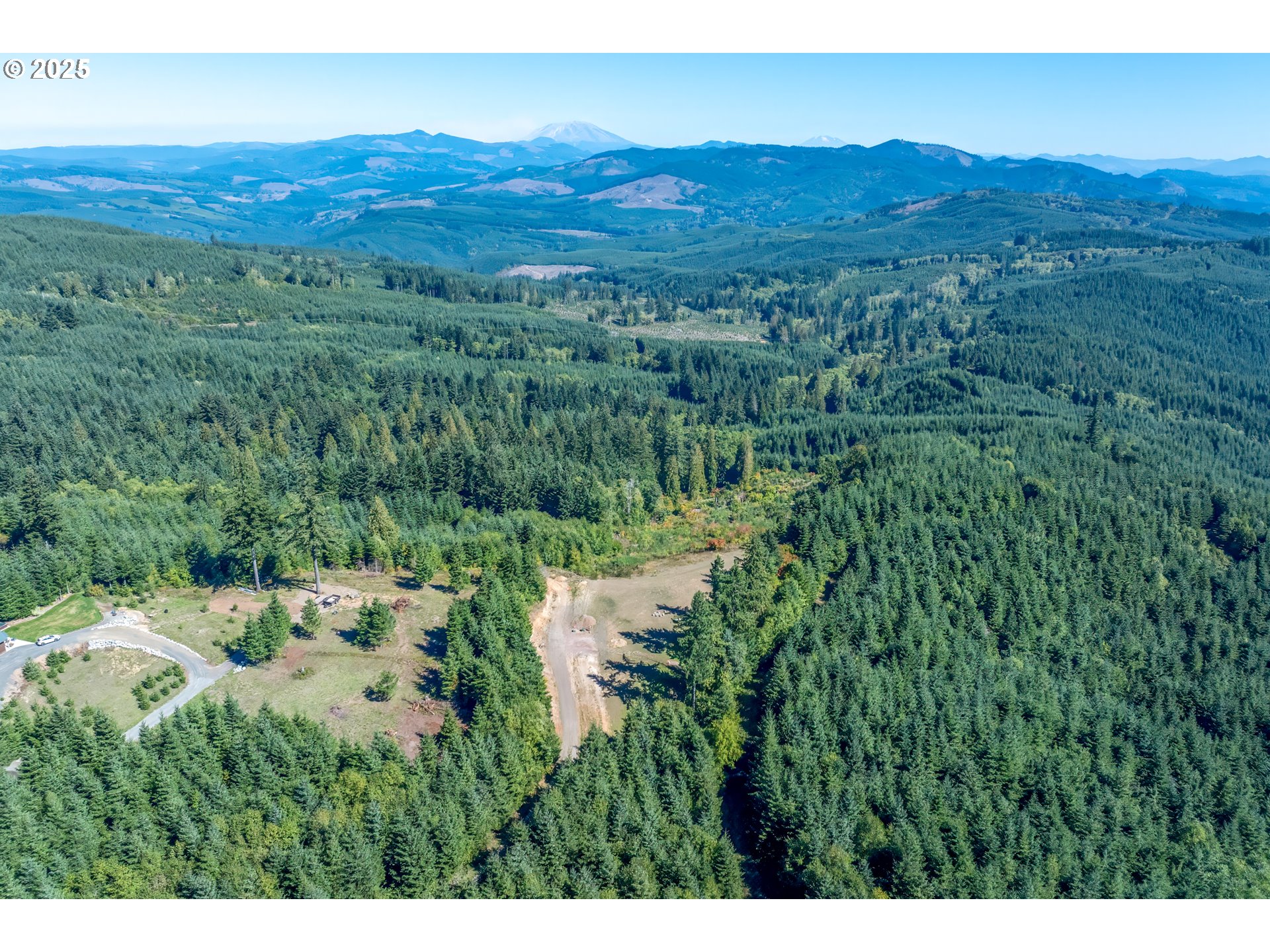 787 Five Peaks Drive Kalama, WA 98625 - Photo 5 of 14 a view of a lush green hillside and a building