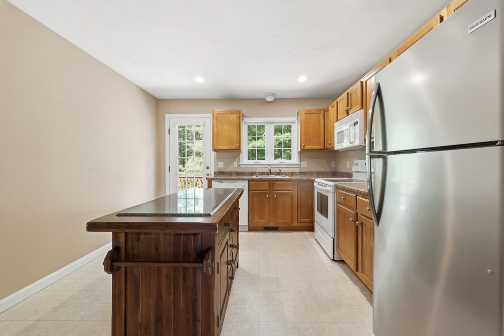 9 Rock Marsh Road, Unit B Wareham, MA 02571 - Photo 15 of 41 a kitchen with a sink a refrigerator and window