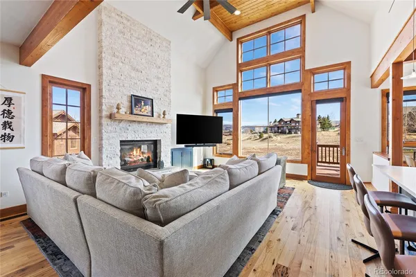 a living room with fireplace furniture and a flat screen tv