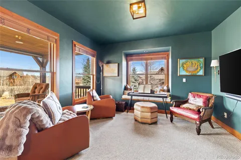 a bedroom with furniture and a large window