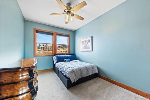 a bedroom with a bed window and a chair