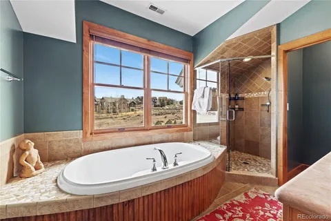 a bathroom with a bathtub and a shower