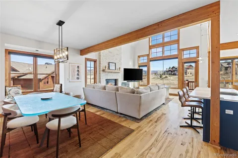 a living room with furniture a flat screen tv and a floor to ceiling window