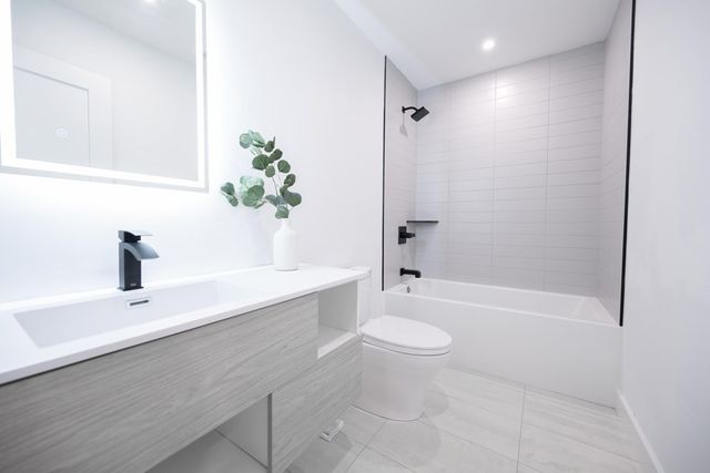 a bathroom with a sink a toilet and bathtub