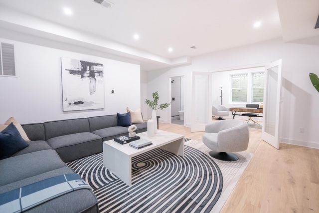 a living room with furniture and wooden floor