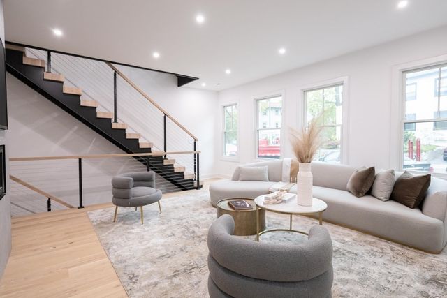 a living room with furniture and stairs