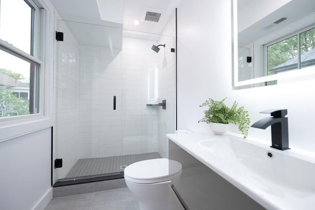 a bathroom with a sink toilet and shower