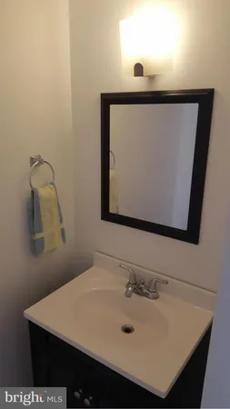 a bathroom with a sink vanity and mirror