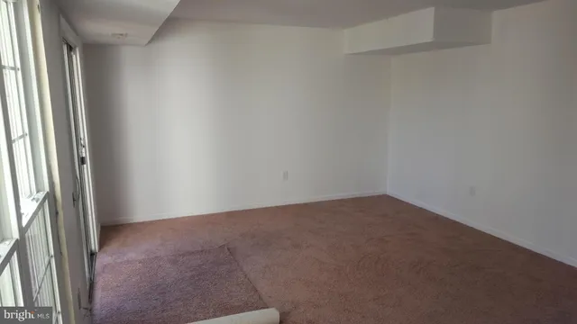 a view of an empty room and a window