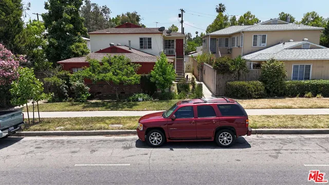 a view of a car parked in front of a house