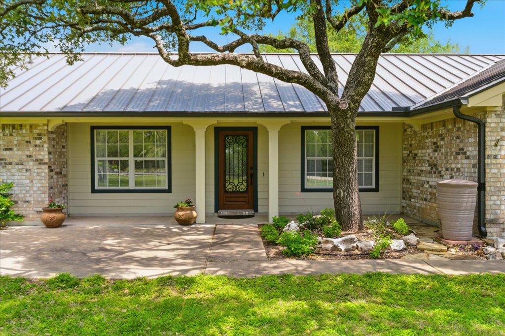 12702 Trails End Road Cedar Park, TX 78641 - Photo 31 of 40 Covered front porch with clean updates and a warm, inviting entry - perfectly positioned beneath mature shade trees.