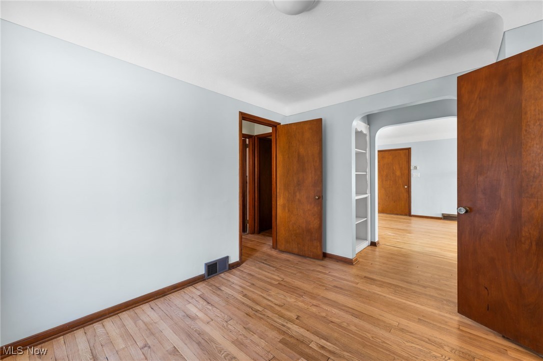 18122 Nottingham Road Cleveland, OH 44119 - Photo 6 of 29 Dining room featuring light wood finished floors and arched walkways