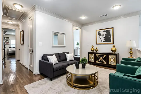 a living room with furniture and a wooden floor