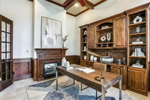a living room with furniture a rug and a wall painting