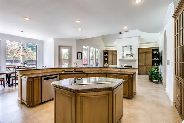 a kitchen with stainless steel appliances granite countertop a sink and a stove