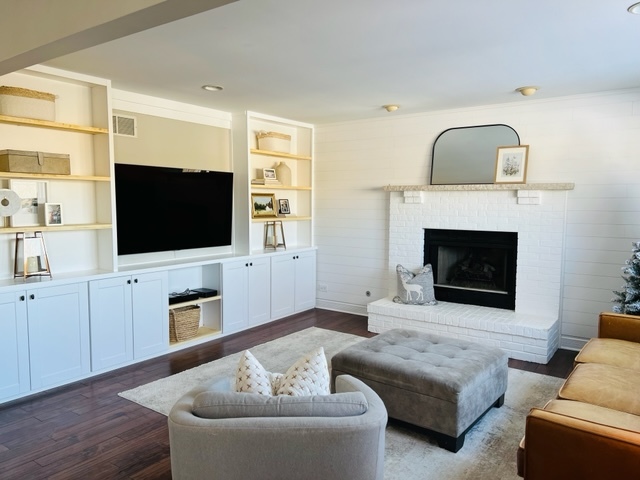 2765 Miller Road Geneva, IL 60134 - Photo 4 of 11 a living room with furniture a flat screen tv and a fireplace