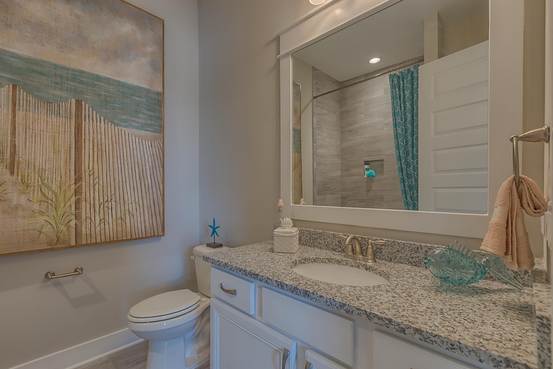 25 East Milestone Drive Inlet Beach, FL 32461 - Photo 15 of 40 a bathroom with a granite countertop sink a mirror and a toilet