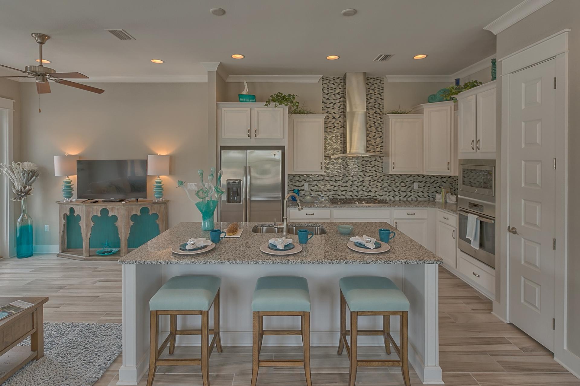 25 East Milestone Drive Inlet Beach, FL 32461 - Photo 25 of 40 a kitchen with granite countertop white cabinets stainless steel appliances and dining table