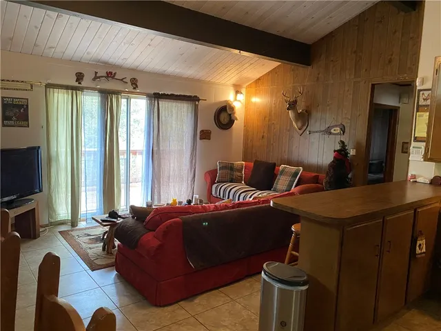 a bedroom with furniture and a flat screen tv