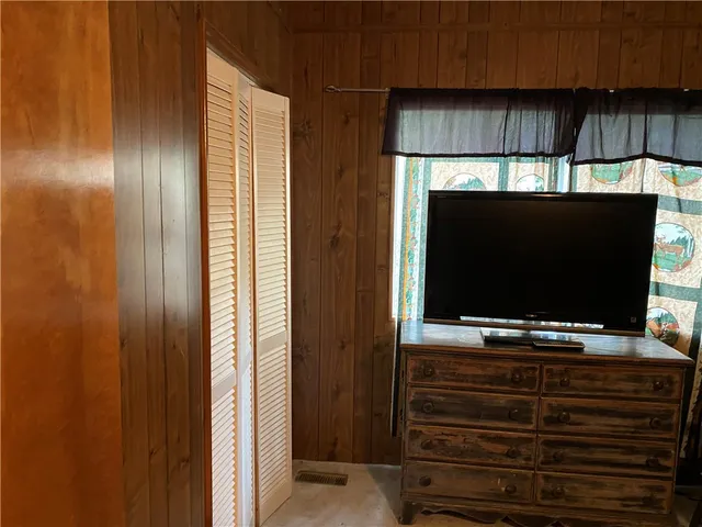 a room with wooden floor and flat screen tv